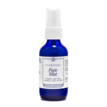 A 1 ounce blue spray bottle of Power Repair Face Mist by Sister Creations is seen against a white background
