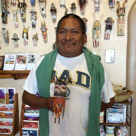 Ferris "Spike" Satala poses for a picture at Winter Sun with a kachina doll he carved