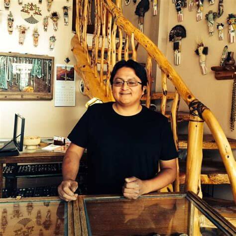 Marlin Honhongva stands behind the counter at Winter Sun Trading Co.