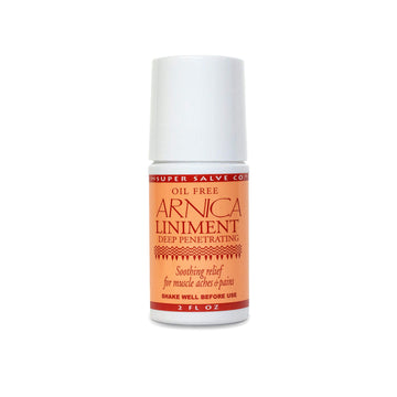 A 2 oz. roll-on bottle of Super Salve Co. Arnica Liniment for soothing muscle aches and pains is seen against a white backdrop at Winter Sun Trading Co.