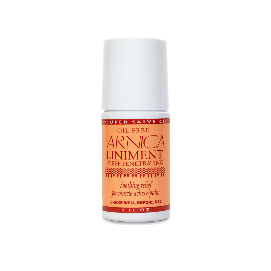 A 2 oz. roll-on bottle of Super Salve Co. Arnica Liniment for soothing muscle aches and pains is seen against a white backdrop at Winter Sun Trading Co.