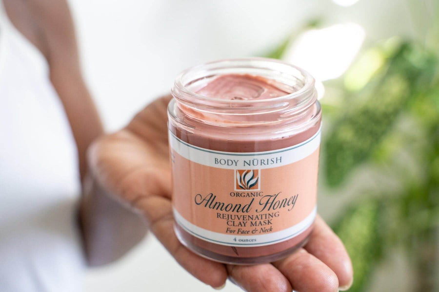 Body Nurish Almon Honey Face Mask being held in a woman's hand.