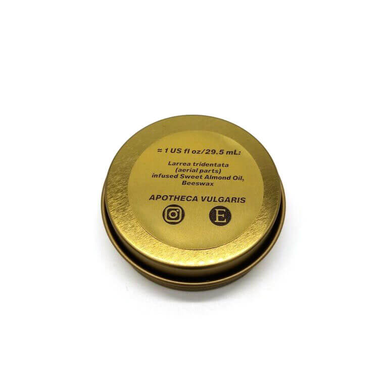 The backside of a 1 oz. tin of Apotheca Vulgaris Creosote Salve with a list of ingredients, all against a white background