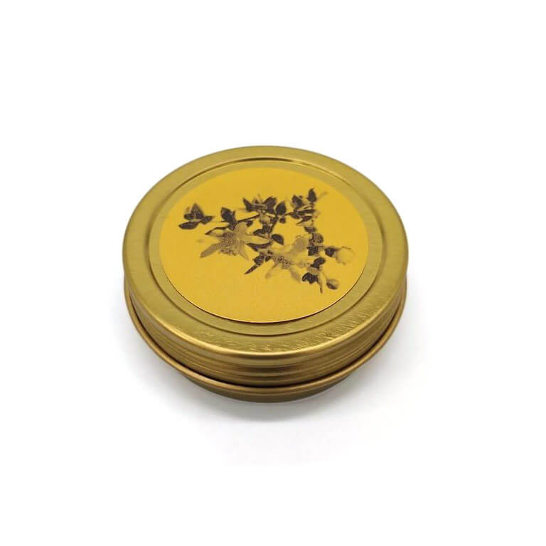 Creosote Salve in a 1 oz. gold container with a picture of creosote on the front, all against a white background