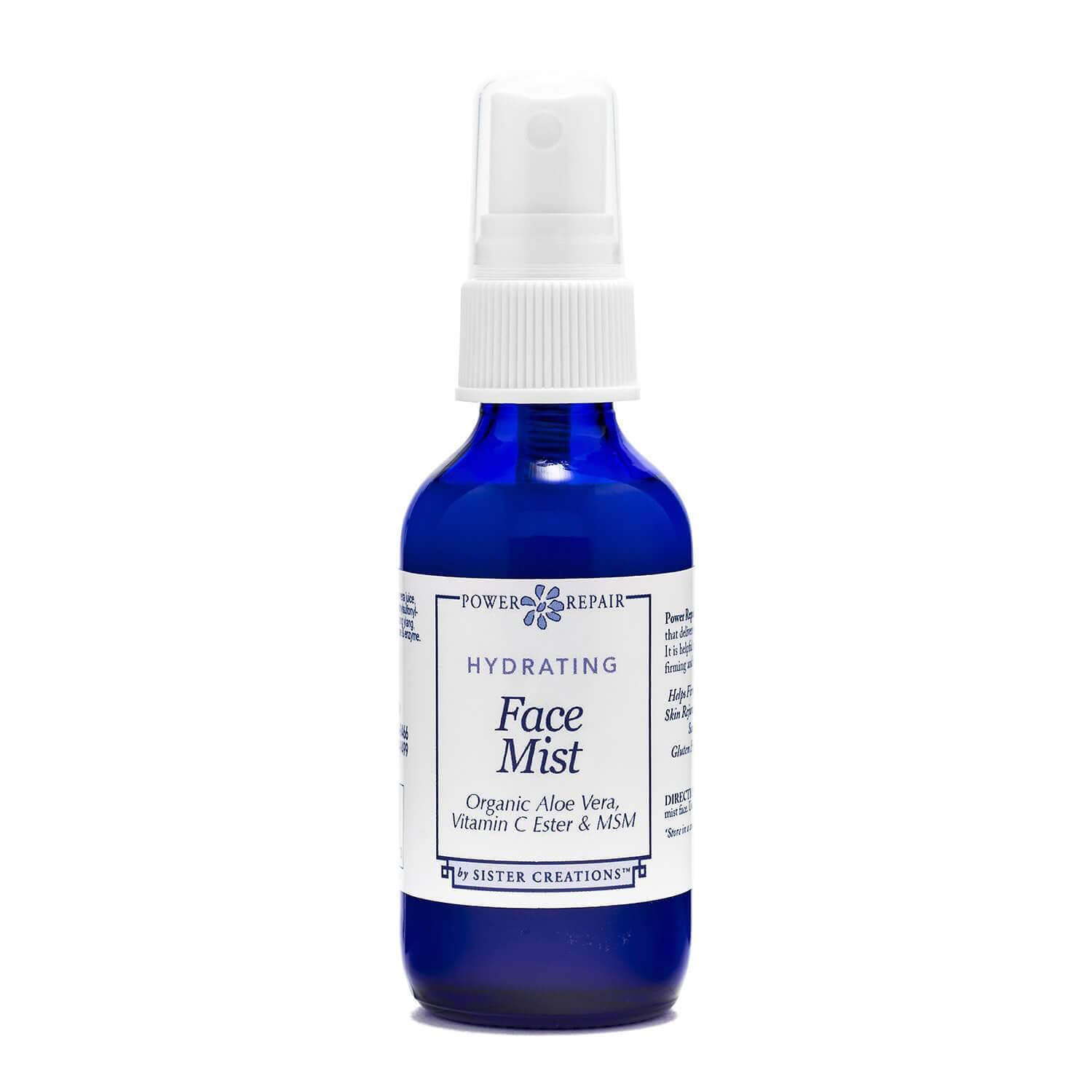 A 1 ounce blue spray bottle of Power Repair Face Mist by Sister Creations is seen against a white background