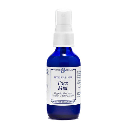 A 1 ounce blue spray bottle of Power Repair Face Mist by Sister Creations is seen against a white background