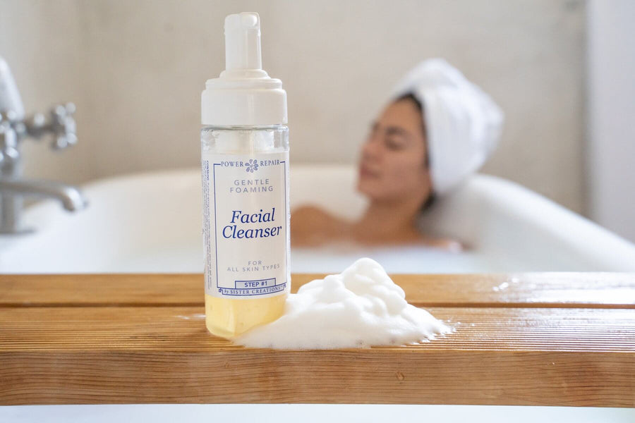 A woman is taking a relaxing bath, and the Power Repair facial cleanser is in the forefront.