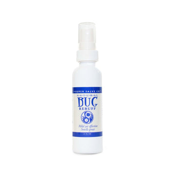 A white spray-top bottle of natural insect repellent and bug spray from The Super Salve Co. is seen against a white backdrop at the Winter Sun Trading Co.
