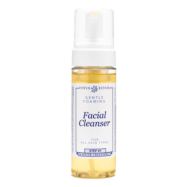 A pump bottle of foaming Power Repair Skin Cleanser by Sister Creations contains yellow liquid