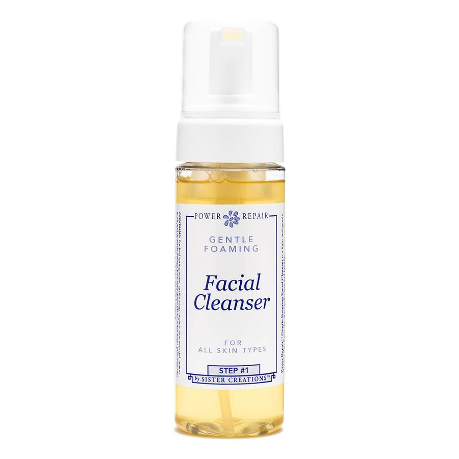 A pump bottle of foaming Power Repair Skin Cleanser by Sister Creations contains yellow liquid